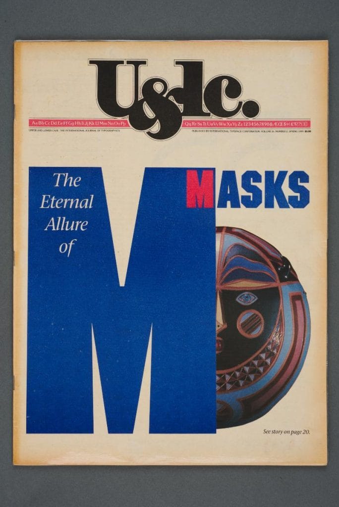 Couverture du magazine U&lc. avec le titre The Eternal Allure of Masks et un grand M bleu partiellement recouvrant un masque coloré