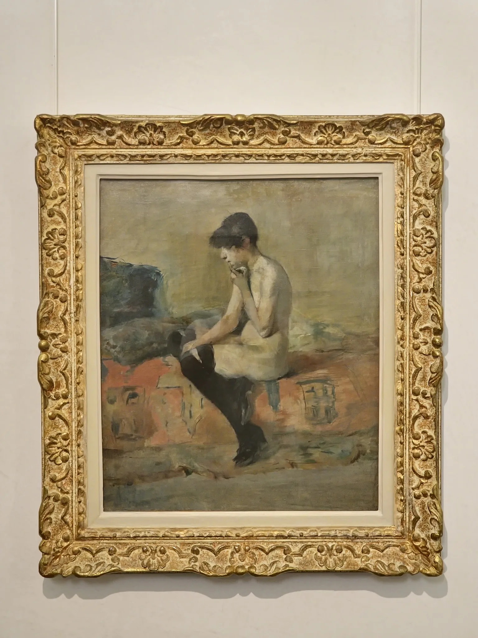 Étude de nu féminin peinte par Henri de Toulouse-Lautrec en 1882, femme assise sur un divan, posture introspective, décor intérieur traité par touches libres.