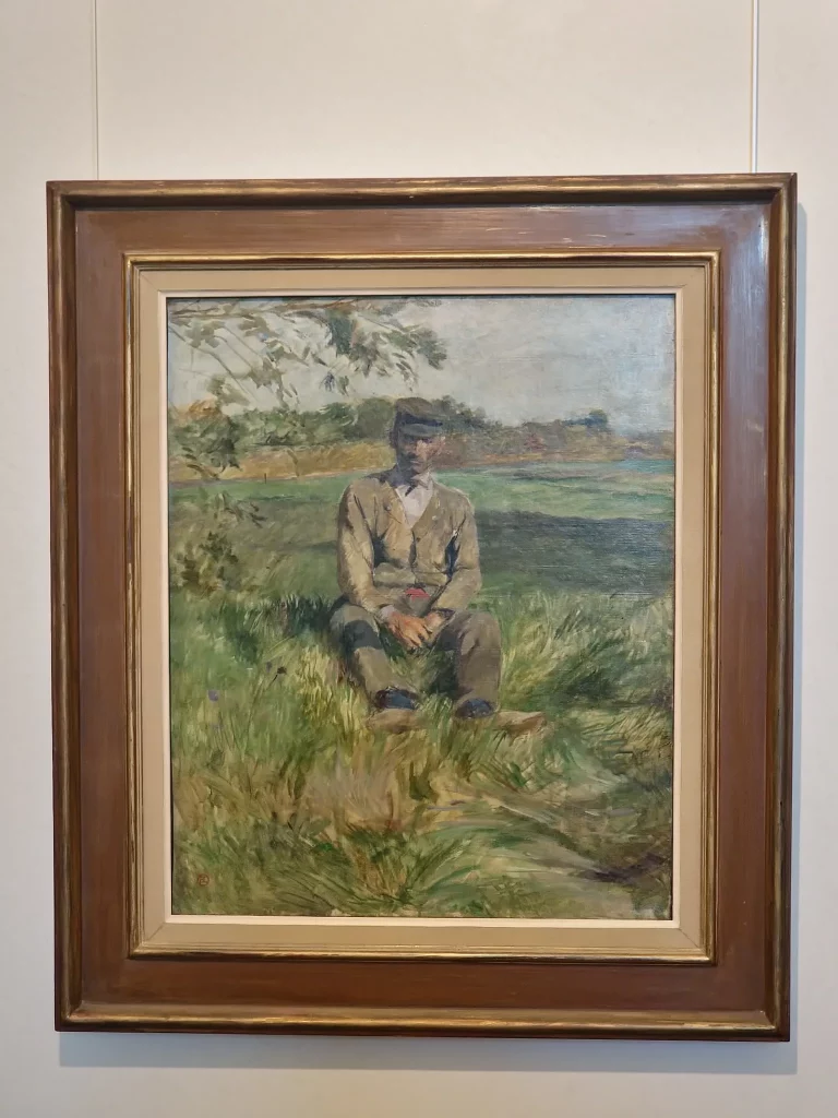 Homme assis dans l’herbe, travailleur à Céleyran, peint par Henri de Toulouse-Lautrec en 1882, scène rurale empreinte de calme.