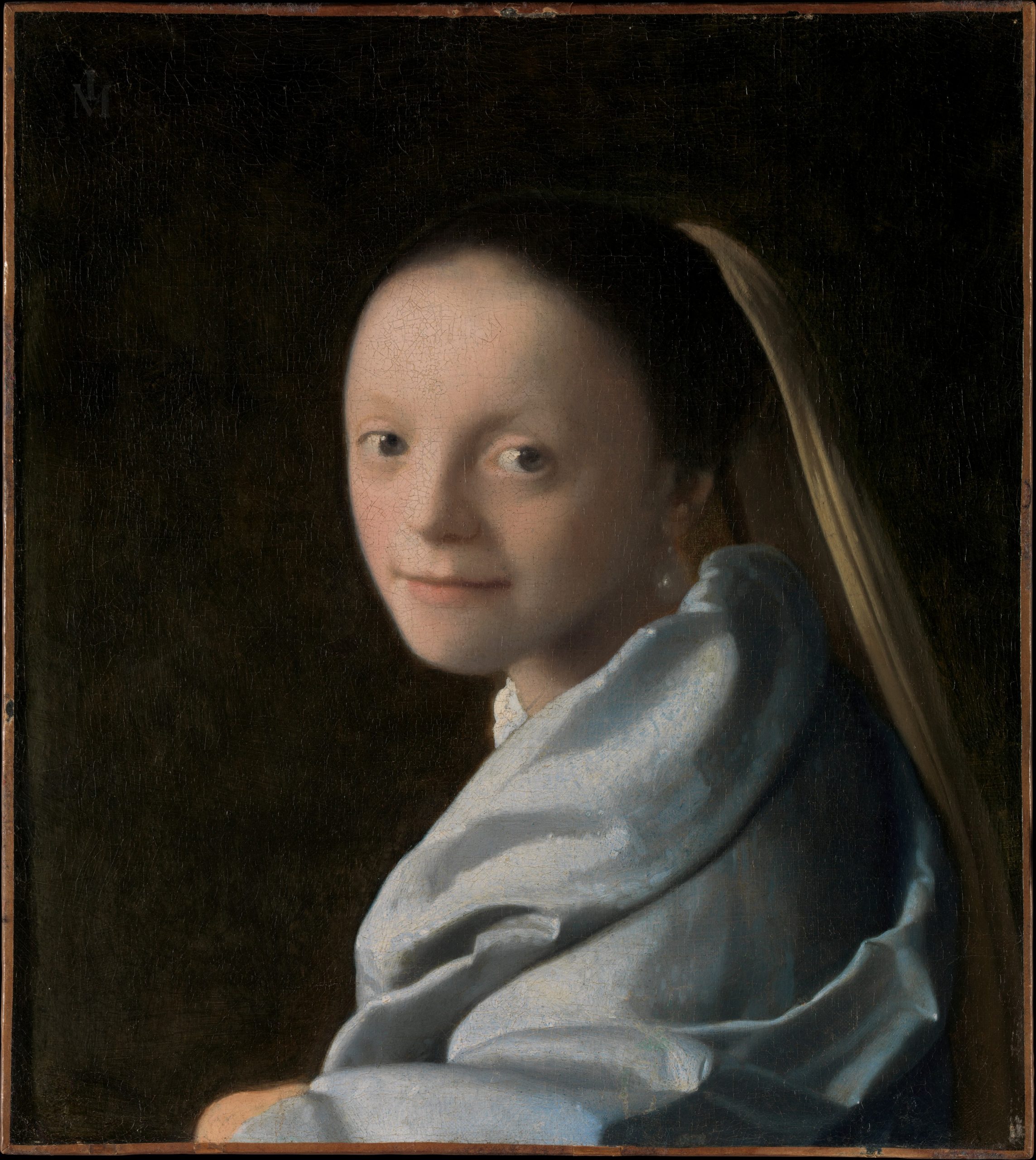 Étude d’une jeune femme au visage éclairé et drapé bleu par Johannes Vermeer